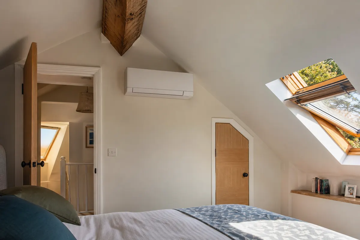 Wall-mounted air conditioning unit in a loft conversion